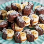 Sliced bananas filled with peanut butter, dipped in chocolate, and frozen for a refreshing treat.